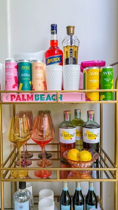 a gold bar cart filled with bottles and glasses