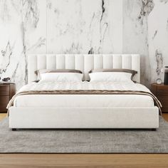 a white bed sitting on top of a wooden floor next to a wall mounted clock