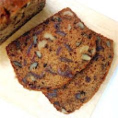 two pieces of chocolate chip cookie sitting on top of a cutting board next to each other