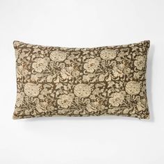 a brown and white pillow on a white wall