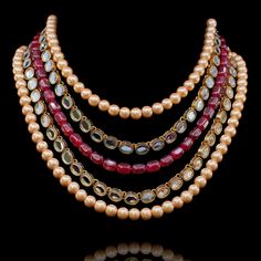 Add a hint of glamour to your style in this standout mala necklace! Beautifully crafted mala featuring strands of pearl beads put together with ruby and kundan stones. Approximate mala length is. Gold-plated on high-quality brass as base metal. Made by order. Kindly allow 5-7 weeks for the delivery of this item. For custom or urgent requests, please contact support@alacouture.com. *Please Note: We use faux stones and beads in all of our jewelry. Luxury Gold Mala With Round Beads, Traditional Mala With Gemstone Beads, Ruby Beads Mala With Pendant, Luxury Gemstone Beaded Mala, Traditional Red Gemstone Beads Mala, Mala Necklace, Faux Stone, Base Metal, Pearl Beads