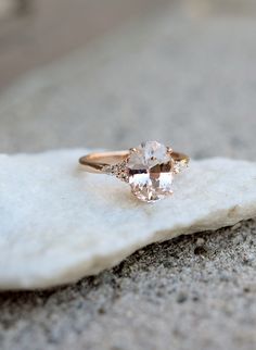 an engagement ring on top of a rock