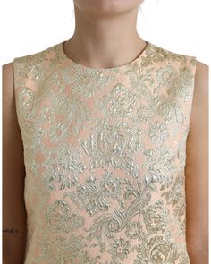 100% Authentic Dolce & Gabbana Metallic Floral Jacquard A-line Mini Dress Color: Peach Zipper closure Logo details Made in Italy Exclusive and high craftsmanship Lined with 92% silk and 8% elastane Material composition: 80% Polyester 11% Nylon 9% Polyester Film Fiber Size on Tag: IT40|S Feminine Fitted Dress For Festive Occasions, Fitted Feminine Dresses For Festive Occasions, Festive Fitted Jacquard Dress, Fitted Jacquard Dress For Festive Occasions, Gold Fitted Jacquard Dress, Fitted Gold Jacquard Dress, Formal Gold Jacquard Dress, Luxury Fitted Brocade Dress, Luxury Silk Festive Dress