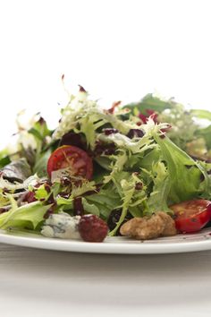 a white plate topped with lettuce and radishes