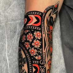 a person with a tattoo on their arm and leg that has an elephant design on it