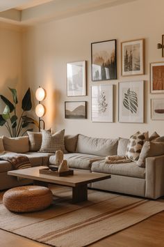 a living room filled with lots of furniture and pictures on the wall above it's coffee table