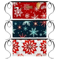 three christmas wrappings with snowflakes and poins on them are stacked in the same pattern