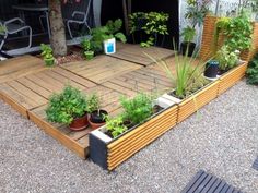 a wooden deck with potted plants on it