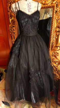 "This gorgeous formal gown is from the 50s by Emma Domb.  Rare solid black.  The underdress is made up of a black shiny acetate. There are two layers of tulle.  The under layer is a coarse tulle to give it its shape.  The outer layer is a finer tulle.  On the bodice and on the skirt are large lace bow appliques. The bodice is boned for structure. Side metal zipper.  There is one repair on the satin underdress near the hem where it looks like the original owners high heel might have gone through. You can't see this  when wearing the dress.  The hem of the tulle in some places has been trimmed (shown) This also does not show because of the fullness and the double layer of tulle.  This is a gorgeous gown and perfect for any formal event or Prom.  It was photographed with an extra petitcoat (n Black Organza Gown For Gala, Black Tulle Ball Gown For Evening, Vintage Black Gown For Wedding, Vintage Black Wedding Gown, Black Ball Gown With Fitted Bodice For Evening, Gothic Ball Gown For Evening, Evening Ball Gown With Tulle Skirt, Black Tulle Ball Gown For Formal Events, Black Tulle Ball Gown For Formal Occasions