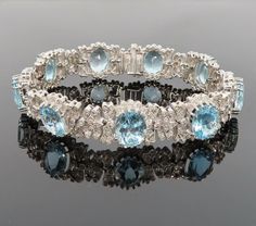 Title:                              Rare 47.0ct Natural Aquamarine & 3.01ct Diamond 18K White Gold Bracelet   Age/Markings:             New old stock                                         Diamonds:                   Approximately 3.01 carats of diamonds, H to I color, VS to SI clarity   Gemstones:                 Approximately 47.0 carats of natural aquamarine gemstones, bright blue color, good clarity   Metal:                            18K white gold                Weight: 43.8 grams   Measurements: 15mm wide, 7.5 inches long   Condition: New old stock condition   Description: Fine diamond & aquamarine 18K white gold bracelet with detailed decorations around the diamonds plus large natural aquamarine gemstones. This fine piece is in new old stock condition and the only wear it has seen White Gold Bracelet, Aquamarine Gemstone, Natural Aquamarine, Bright Blue, Vintage Watches, Aquamarine, Antique Jewelry, Diamond Bracelet, Vintage Antiques