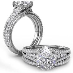 two wedding rings with diamonds on each side and one diamond in the middle, set against a white background