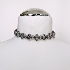 This exquisite choker necklace features a beautiful antique silver hue, crafted with strong and skin-friendly, hypoallergenic stainless steel mini jump rings. Utilizing the timeless technique of chainmail, this necklace combines durability with a touch of elegance. DETAILS: - 15 or 17 inches, jump rings, lobster clasp. - Perfect for every day wear or as a gift - This necklace is made with stainless steel, which is non tarnishing and considered hypoallergenic. Stainless steel and steel plated care: - To store the product, please make sure it's dry and place it in the included air- tight box. - Avoid chemicals, salt and swimming with the product. Silver Stainless Steel Choker With Adjustable Chain, Adjustable Silver Choker With Oxidized Finish, Adjustable Silver Oxidized Choker, Metal Chainmail Choker As A Gift, Metal Choker With Oxidized Finish, Gothic Silver Choker With Adjustable Chain, Adjustable Metal Choker With Oxidized Finish, Adjustable Silver Choker With Lobster Clasp, Silver Chainmail Choker As A Gift