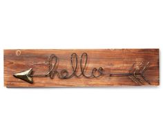 a wooden sign with an arrow and the word hello on it