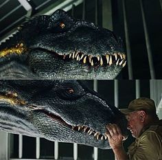 a man is touching the head of a large dinosaur with his mouth open and teeth out