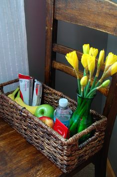 a wicker basket filled with fruit and flowers