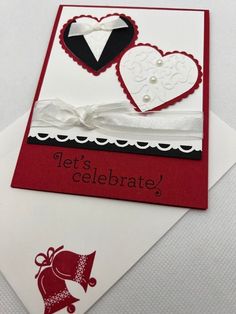 a red and white card with two hearts on it