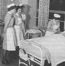 an old black and white photo of nurses tending to a patient