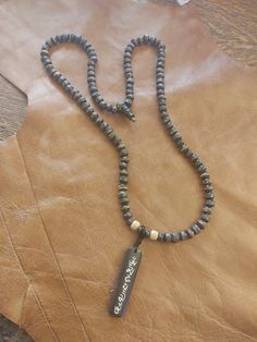 This Tibetan Buddhist meditation necklace features a genuine Tibetan Buddhist sacred Om Mantra talisman made from dyed yak bone. The 108 mala beads from Nepal are made from genuine black dyed yak bone and inlaid with copper, coral and turquoise. Necklace Guide, Tibetan Mantra, Buddhist Mantra, Om Mantra, Buddhist Meditation, Mala Bead Necklace, Buddhist Traditions, 108 Mala Beads, Hippie Necklace