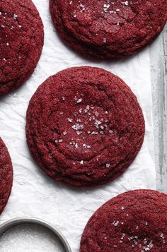 red velvet cookies are on a baking sheet with sugar sprinkled on the top