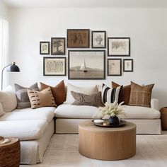 a living room filled with lots of furniture and pictures on the wall above it's coffee table