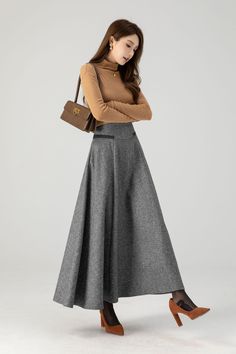 This grey winter wool skirt is a classic piece of tailoring that will see you through rain or shine. It is cut with a flattering flared skirt to give you a wonderful shape. The winter skirt is perfect classic styling and ends at the ankle.  DETAILS: * 30% wool, 30% fiber, 40% polyester * Fully satiny liner * Two side pockets * Right zipper closure * Maxi wool skirt,long skirt * A line skirt, swing skirt * High waist skirt * Daily skirt * Perfect for Winter, autumn * Dry clean * Lean More about the items From the FAQs on the page bottom MODEL SIZE Bust 85 cm(33.4") Waist 67 cm(26.7") Height 168cm (5' 6") She wears size XS Choose CUSTOM Order if you * Need a better fit * Can't find your size in our size Chart * Change the Style * Chang the Length * Your Height is not Between 5'1" - 5"9" * Yo Maxi Wool Skirt, Wool Maxi Skirt Outfit, Winter Wool Skirt, Custom Skirt, Long Wool Skirt, Classic Capsule Wardrobe, Skirt A Line, Ankle Length Skirt, Maxi Skirt Outfits