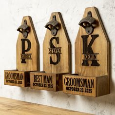 three wooden plaques with the names of different towns and cities on them, hanging on a wall