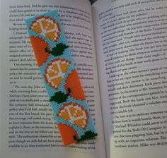 an orange and blue bookmark is sitting on top of an open book