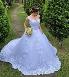 a woman in a blue wedding dress standing outside