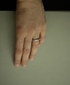 Two inseparable interlocking bands, one slender and the other with a bit of extra weight. Handcrafted in solid sterling silver with a polished finish. A distinct and timeless piece from our most recent series of rings signifying closeness. This ring looks beautiful on its own, but it can be layered with other silver and gold pieces as well. Thinner band: 1.5mm, 925 sterling silver Heavier band: 2.0mm, 925 sterling silver Shown in the fourth photo with our Gold Lovers Ring. Can't find your size? Minimalist Silver Double Band Midi Rings, Sterling Silver Rings With Polished Finish, Minimalist Jewelry For Anniversary With Shiny Finish, Minimalist Shiny Jewelry For Anniversary, Minimalist Open Ring Jewelry With Polished Edges, Timeless Open Ring Band With Polished Finish, Modern Adjustable White Gold Signet Ring, Everyday White Gold Rings With Polished Edges, Classic Adjustable Double Band Midi Rings