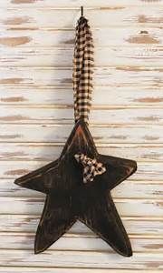 a wooden star ornament hanging on a wall