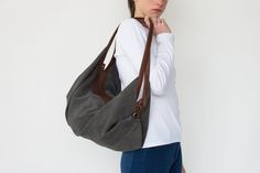 "DeLuna is a soft suede leather bag designed for women who love to carry slouchy handbags. Featured in this listing in grey suede leather, it has plenty of room for all your essentials which makes it the perfect carryall bag. The contrast of the two-tone colors on the straps and on the main body is what makes the design unique and stand out. The straps sit comfortably on your shoulder and the bag is secured with a top zipper closure. Inside the bag, there is one main compartment with a large zip Casual Suede Hobo Bag For Travel, Versatile Suede Hobo Bag With Soft Leather, Versatile Suede Hobo Bag With Soft Leather Details, Suede Hobo Shoulder Bag, Versatile Suede Tote Hobo Bag, Versatile Suede Hobo Shoulder Bag, Versatile Suede Hobo Tote Bag, Everyday Suede Hobo Bag, Versatile Suede Shoulder Bag For Everyday Use