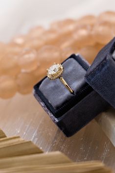 an engagement ring sits on top of a box