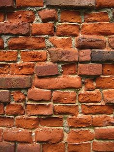 an orange brick wall is shown in close up