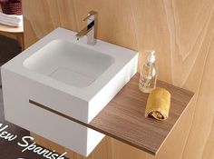 a white sink sitting on top of a wooden counter