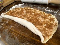 an uncooked pizza dough on a wooden table