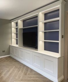 a large entertainment center with built - in shelving