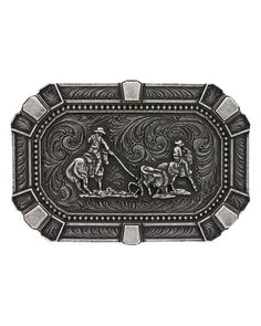 Team Roper Classic Belt Buckle Our medium sized rectangular buckle features cut corners and traditional western engraving patterns. The center features a team roping figure framed with traditional deco flourishes in alternating light and darker silver tones around the corners and edges in a bold attitude fashion. Classic western filigree markings decorate the back for added detail. It has a standard 1.5" swivel and is made of silver over a solid cast metal alloy base. Measures 4" x 2.75". Top off your favorite outfit with this Team Roping Attitude Belt Buckle and you will be ready to hit the town in style. Western Antique Belt Buckles In Rectangular Shape, Western Antique Rectangular Belt Buckle, Western Style Rectangular Antique Belt Buckle, Western Candle Holders, Western Picture Frames, Engraving Patterns, Smith And Western, Team Roper, Western Games