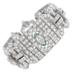 The art deco bracelet is finely crafted in platinum with round diamonds weighing approximately total of 20.00 carat and marquise diamonds weighing approximately total of 2.00. On the side there are also emeralds and onyx. Circa 1930's. Classic Evening Platinum Bracelets, Timeless Platinum Bracelets For Evening, Luxury Marquise Diamond Bracelets, Luxury Diamond Marquise Bracelets, Luxury Marquise Diamond Bracelet For Formal Occasions, Art Deco Platinum Diamond Bracelet, Art Deco White Gold Diamond Bracelet, Art Deco Diamond Bracelet In White Gold, Art Deco Cubic Zirconia Diamond Bracelet For Formal Occasions