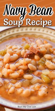 a bowl of soup with beans and sausage in it on top of a wooden table