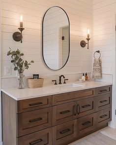 a bathroom with two sinks and a large mirror on the wall over it's counter