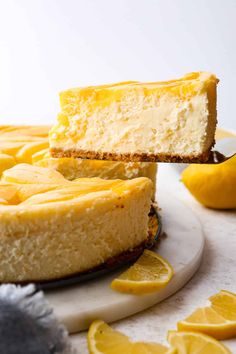 two slices of cheesecake with lemons on the side