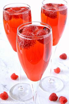 raspberry bellini in wine glasses on a marble table