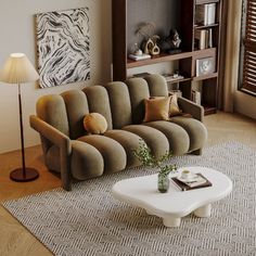 a living room with a couch, coffee table and bookshelf in the corner