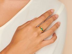 A gorgeous design, this cocktail ring is boldly unexpected. Stunning in its simplicity, the ring features an inlay pear-shaped emerald beautifully set in a gold band that packs a punch. Emerald stone size: 3mm x 5mm; Band is made of 14k gold over sterling silver. Adjustable band between size 7-9 Hypoallergenic, nickel and lead free Tarnish resistant Yellow Gold Teardrop May Birthstone Ring, Yellow Gold Teardrop Ring For May Birthstone, Green Teardrop-shaped Promise Ring, Gold Teardrop Emerald Promise Ring, Gold Teardrop Emerald Ring, Caro Emerald, Dome Ring, Domed Ring, Emerald Stone