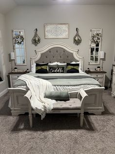 a bedroom with a large bed, dressers and mirror on the wall above it