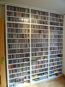 a large book case filled with lots of movies