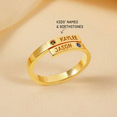 "A shiny dainty personalized ring with names and sparkly birthstones of your choice. This ring is a unique gift for coming up Mother's Day.  ► PRODUCT INFORMATION * Material: High Quality Solid 925 Sterling Silver * Finishing: Silver, Gold or Rose Gold * Band with: 3/32 inch (2.5mm) * By default, silver items come with BLACK engraving and gold-plated item comes with CLEAR engraving ► HOW TO ORDER & ADD PERSONALIZATION * Select your preferred color and ring size from the menu. * Add item to cart Anniversary Birthstone Ring With Names, Personalized Birthstone Ring For Gift, Custom Name Round Birthstone Ring For Anniversary, Personalized Gold Dainty Birthstone Ring, Personalized Stackable Rings For Anniversary With May Birthstone, Personalized Birthstone Birthday Ring, Customizable Gold Birthstone Ring For Anniversary, Personalized Yellow Gold Birthstone Ring For Anniversary, Personalized Gold Stackable Rings For Birthday