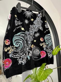 This soft black velvet mini skirt features heavily embellished exquisite Stars, Cosmos and Galaxies embroidered onto tulle and a silver-toothed YKK zip. The skirt has a slight stretch to it. Check out our website for more 🌸 https://eccentriclothing.bigcartel.com/  Follow us on Instagram @eccentricclothing    💖 Cowgirl Chaps, Black Velvet Mini Skirt, Black Velvet Skirt, Handmade Tapestries, Velvet Mini Skirt, Embroidered Tulle, Velvet Skirt, Fabric Belt, Soft Black