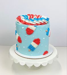 a blue cake with red, white and blue decorations