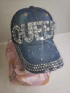 Finish your look with this fabulous Queen Rhinestone Hat that provides a touch of personality and is especially great for that bad hair day. Denim rhinestone one size fits most 100% Cotton Adjustable Rhinestone Cap, Trendy Rhinestone-embellished Cap, Trendy Rhinestone Cap, Trendy Summer Hats With Rhinestones, Trendy Rhinestone Adjustable Baseball Cap, Trendy Rhinestone Baseball Cap, Adjustable Rhinestone Baseball Cap For Party, Rhinestone Baseball Cap, Casual Rhinestone Hat, One Size